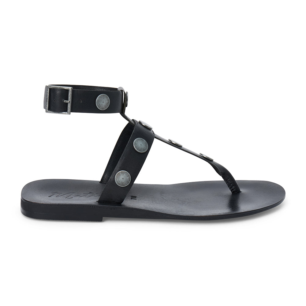 Black strappy thong sandal with metal studs and ankle buckle shown on a white background.