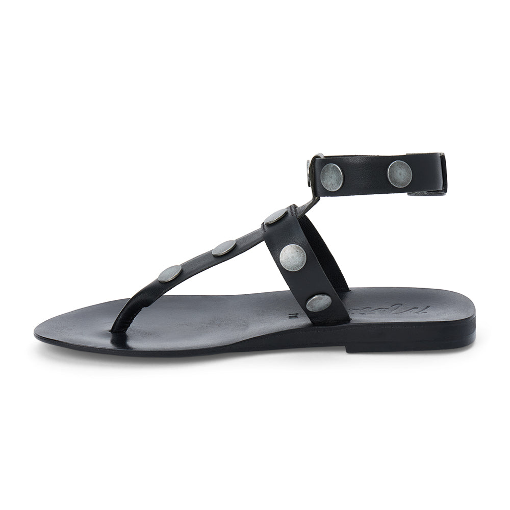 Black strappy thong sandal with metal studs and ankle buckle shown on a white background.