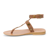 Tan suede strappy thong sandal with metal studs and ankle buckle shown on a white background.