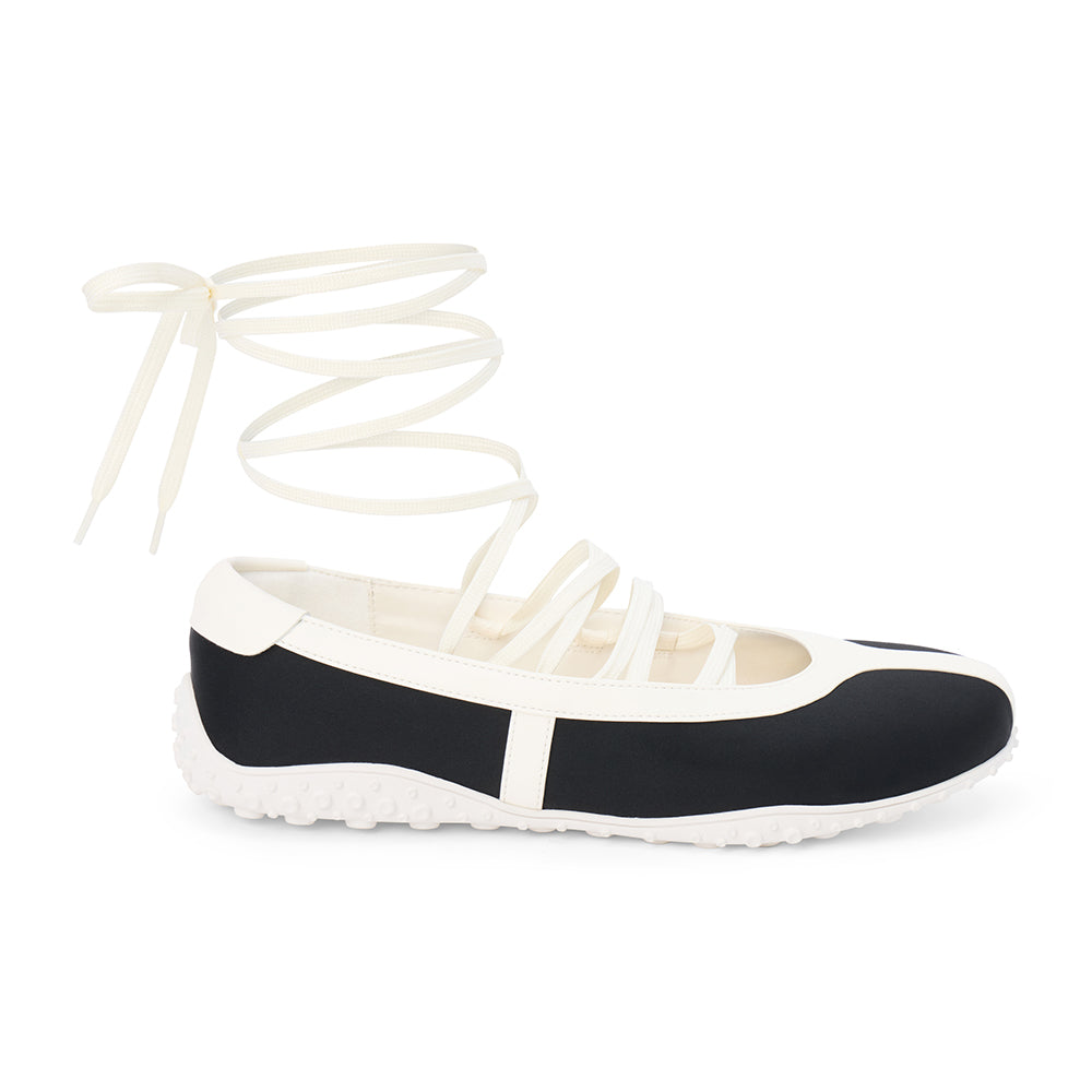 Black vegan sneaker-ballet flat hybrid with contrast trim and wraparound ankle laces, shown on a white background.