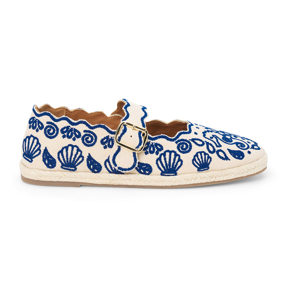 Blue embroidered canvas flat with scalloped edges and buckle strap shown on a white background.