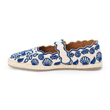 Blue embroidered canvas flat with scalloped edges and buckle strap shown on a white background.