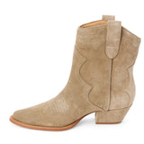 Taupe suede ankle boot with western stitching, a pointed toe, stacked heel, and pull tab, shown in side profile on a white background.