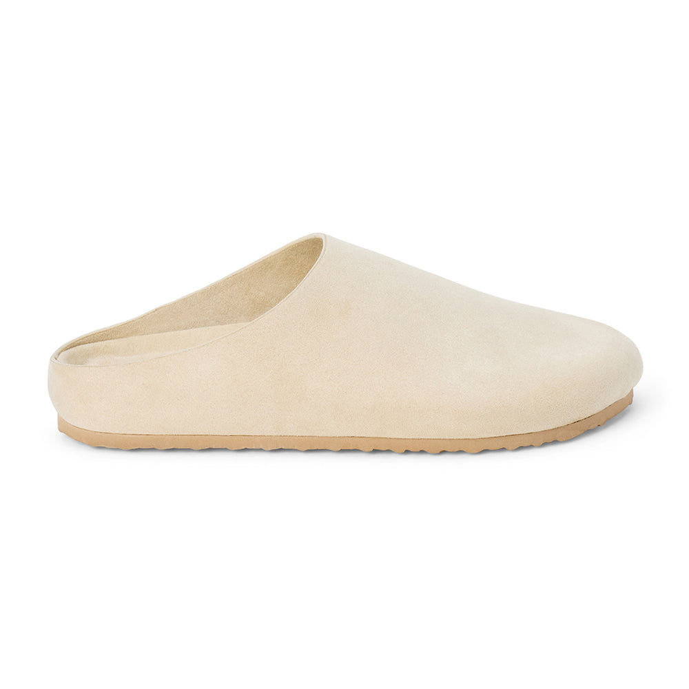 Vegan ivory faux suede clog with a smooth closed toe, minimalist upper, open back, and tan low-profile sole shown on a white background.