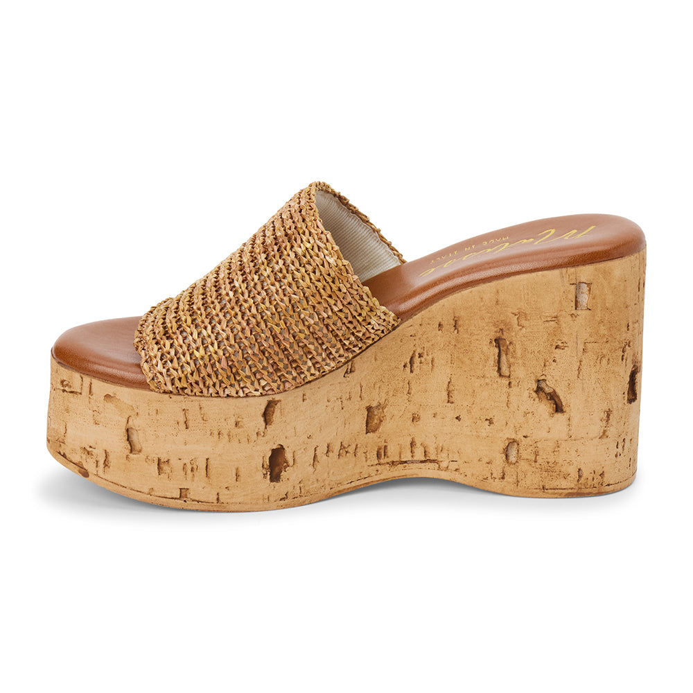 Tan raffia platform sandal with cork wedge and wide strap shown on a white background.