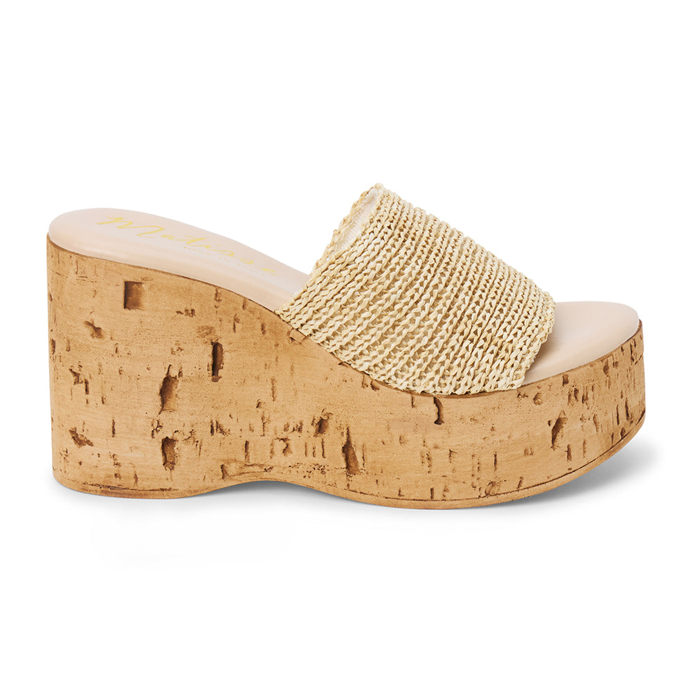 Ivory raffia platform sandal with cork wedge and wide strap shown on a white background.