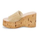 Ivory raffia platform sandal with cork wedge and wide strap shown on a white background.