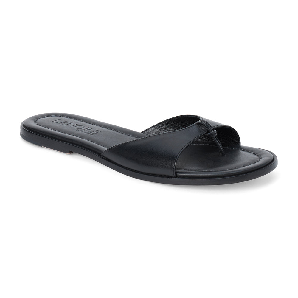 Black leather flat sandal with minimalist thong strap and padded footbed, shown on a white background.