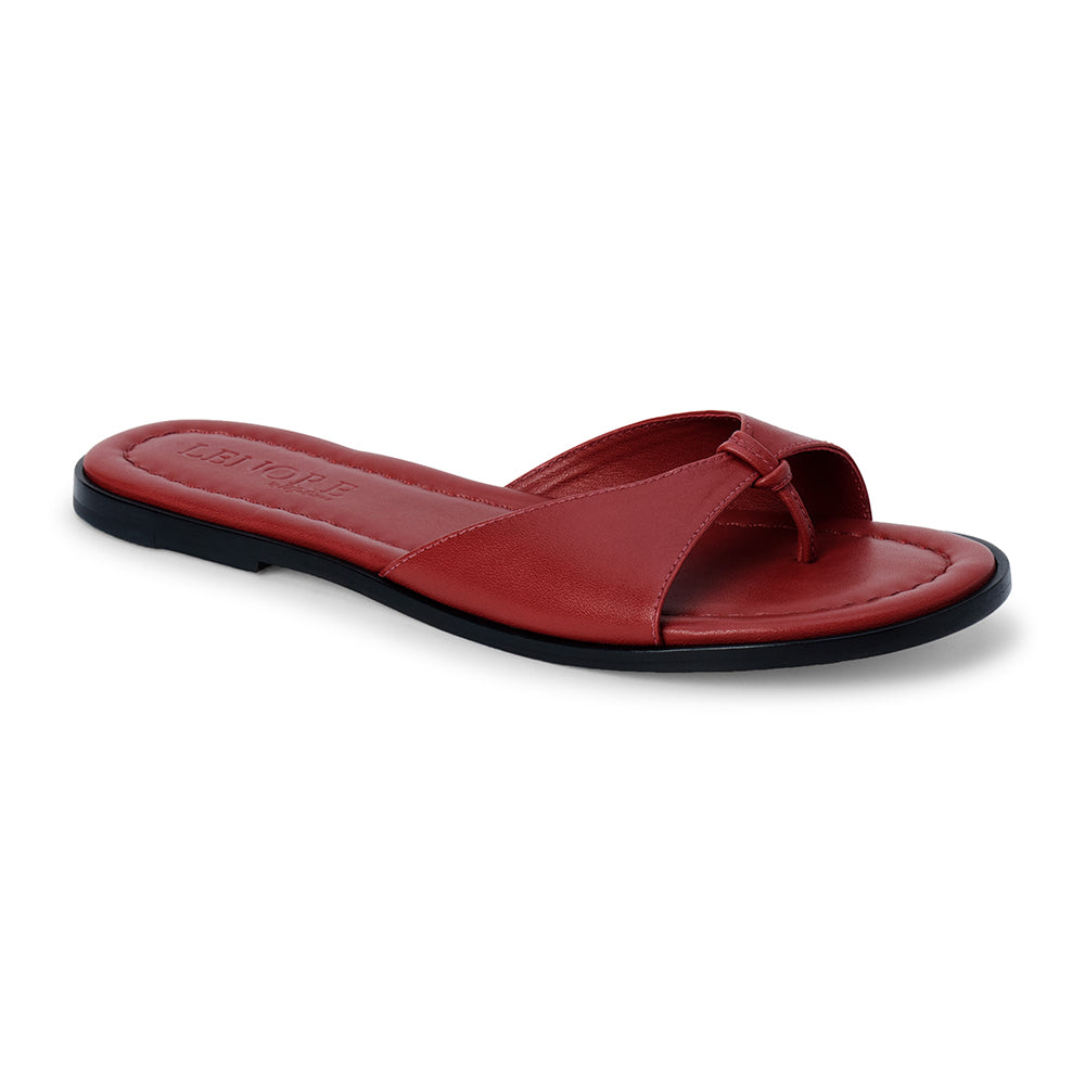 Cherry red leather flat sandal with minimalist thong strap and padded footbed, shown on a white background.
