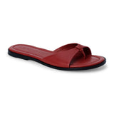 Cherry red leather flat sandal with minimalist thong strap and padded footbed, shown on a white background.