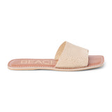 Tan suede slide sandal with a wide single strap and flat sole, shown on a white background.
