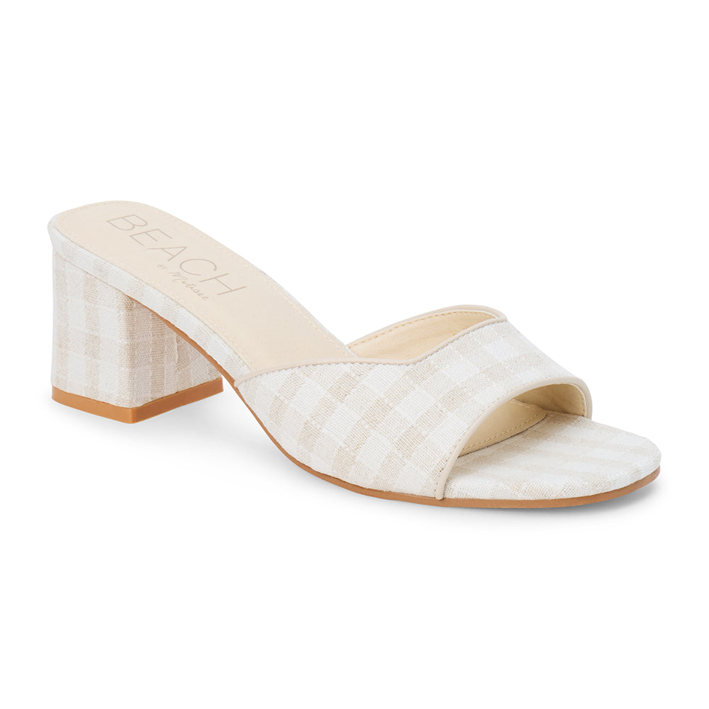 Beige check textile vegan heeled slide with wide strap and block heel, shown on a white background.