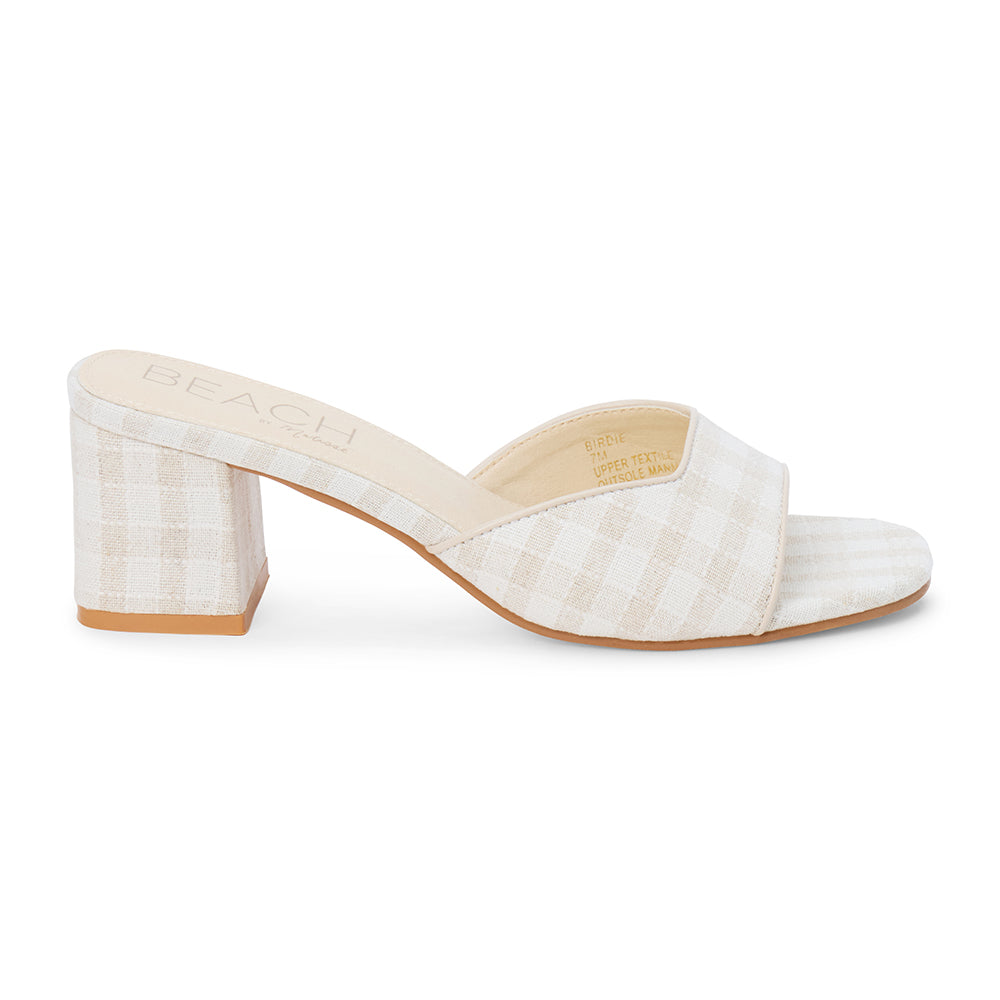 Beige check textile vegan heeled slide with wide strap and block heel, shown on a white background.