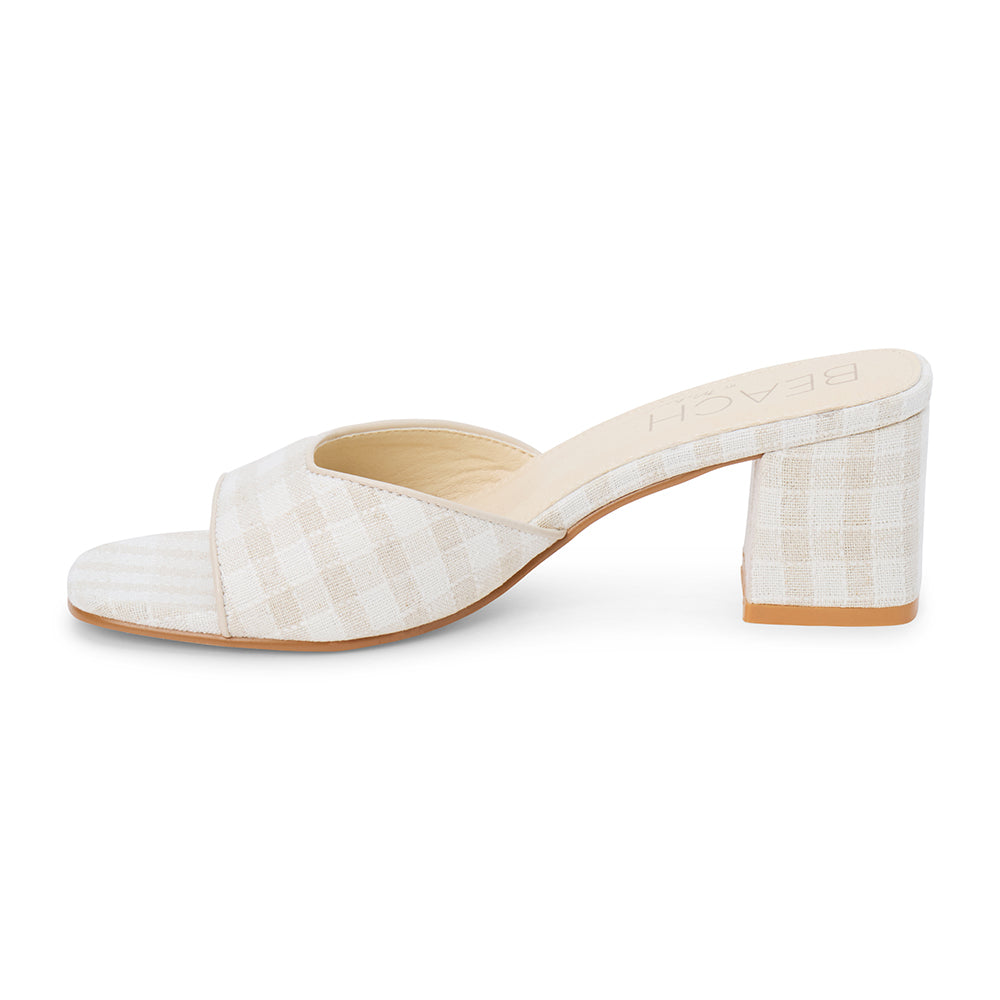 Beige check textile vegan heeled slide with wide strap and block heel, shown on a white background.