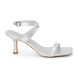 Silver faux leather heeled sandal with slim ankle strap, open square toe, mid-height heel, and buckle closure, shown on a white background.