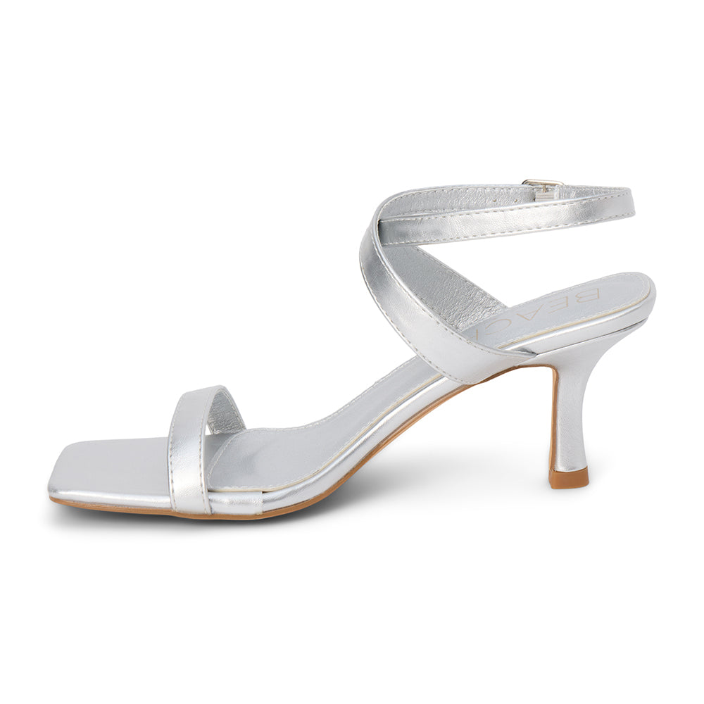 Silver faux leather heeled sandal with slim ankle strap, open square toe, mid-height heel, and buckle closure, shown on a white background.