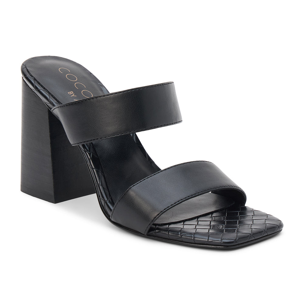 Black faux leather heeled sandal with wide straps, woven footbed, and tall block heel, shown on a white background.