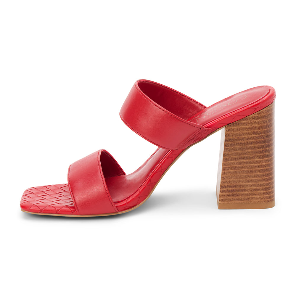 Red faux leather heeled sandal with wide straps, woven footbed, and tall block heel, shown on a white background.
