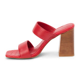 Red faux leather heeled sandal with wide straps, woven footbed, and tall block heel, shown on a white background.