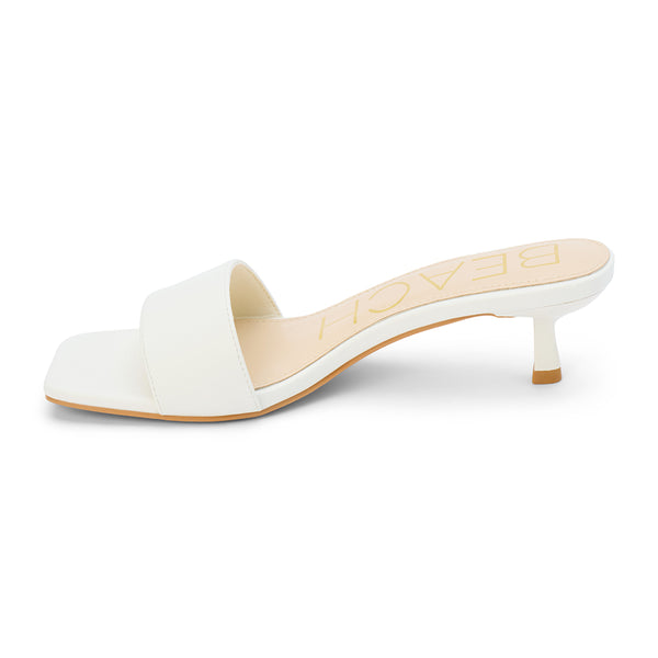 Minimalist and chic, these white kitten heel mules feature a sleek square toe, soft faux leather upper, and a comfortable low heel. A versatile staple for effortless elegance.