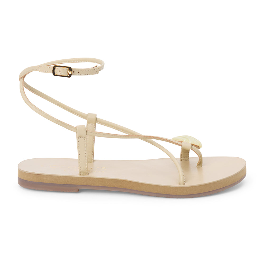 Ivory leather sandal with thin straps and wraparound ankle strap shown on a white background.