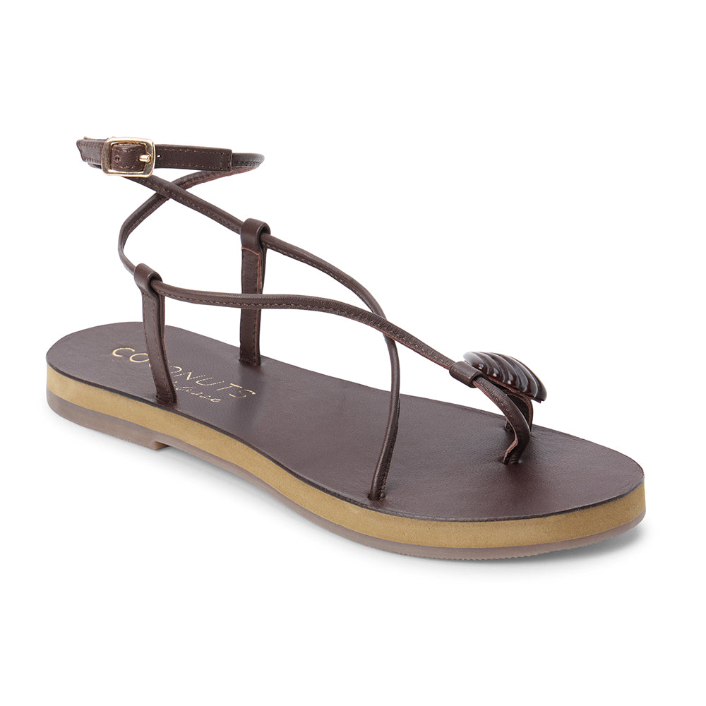 Brown leather sandal with thin straps and wraparound ankle strap shown on a white background.