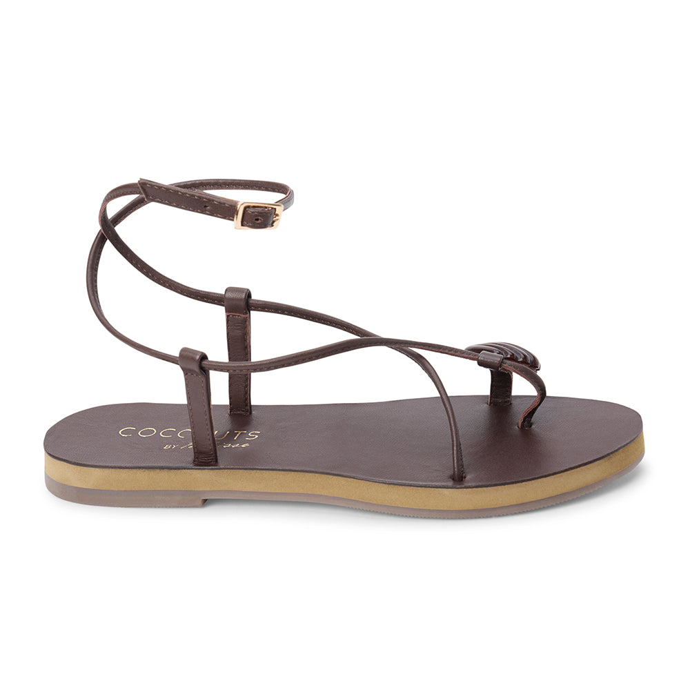 Brown leather sandal with thin straps and wraparound ankle strap shown on a white background.