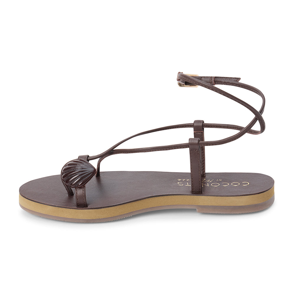 Brown leather sandal with thin straps and wraparound ankle strap shown on a white background.