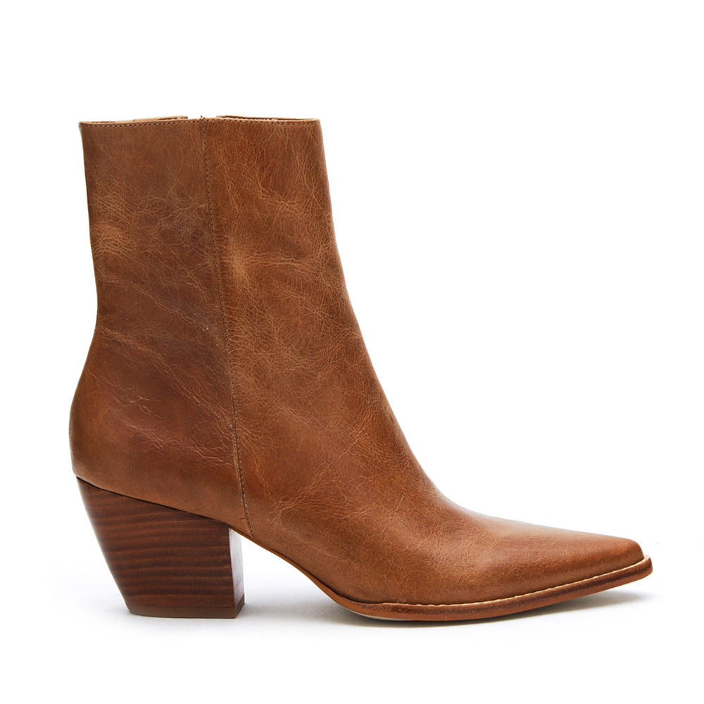 Crafted from rich brown leather, these ankle boots feature a sleek pointed toe, stacked block heel, and side zipper. A classic style with a modern edge.