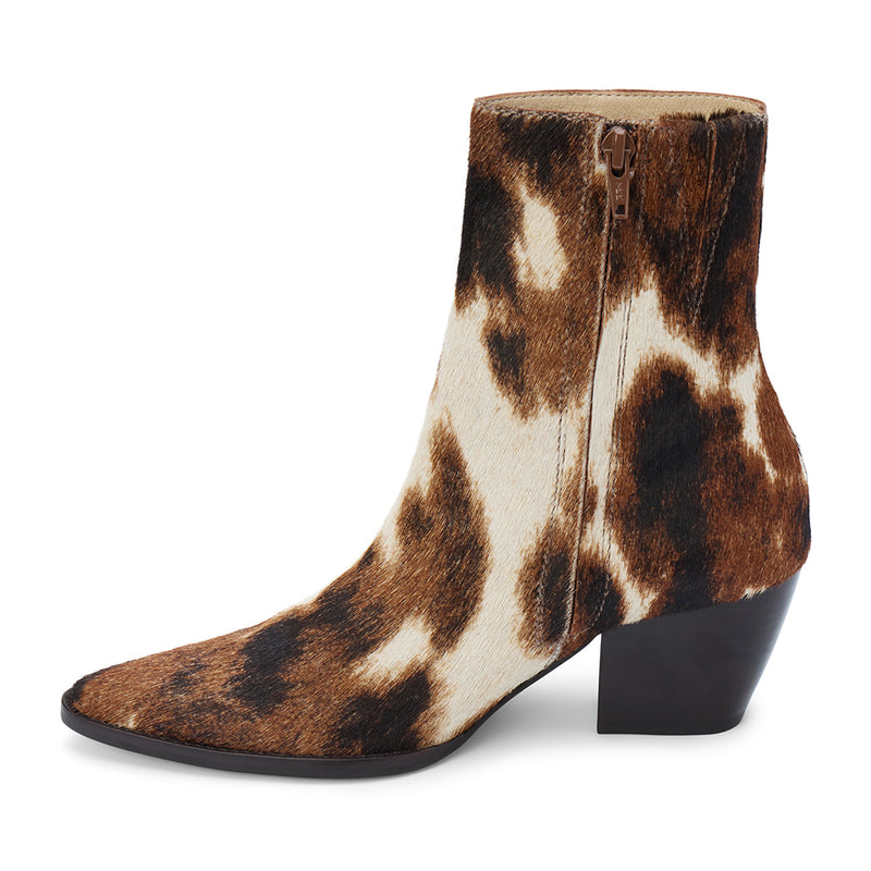 Caty Ankle Boot – Matisse Footwear – Cow-print haircalf ankle boot with a pointed toe, stacked block heel, and side zipper. A bold Western-inspired silhouette with statement-making texture.