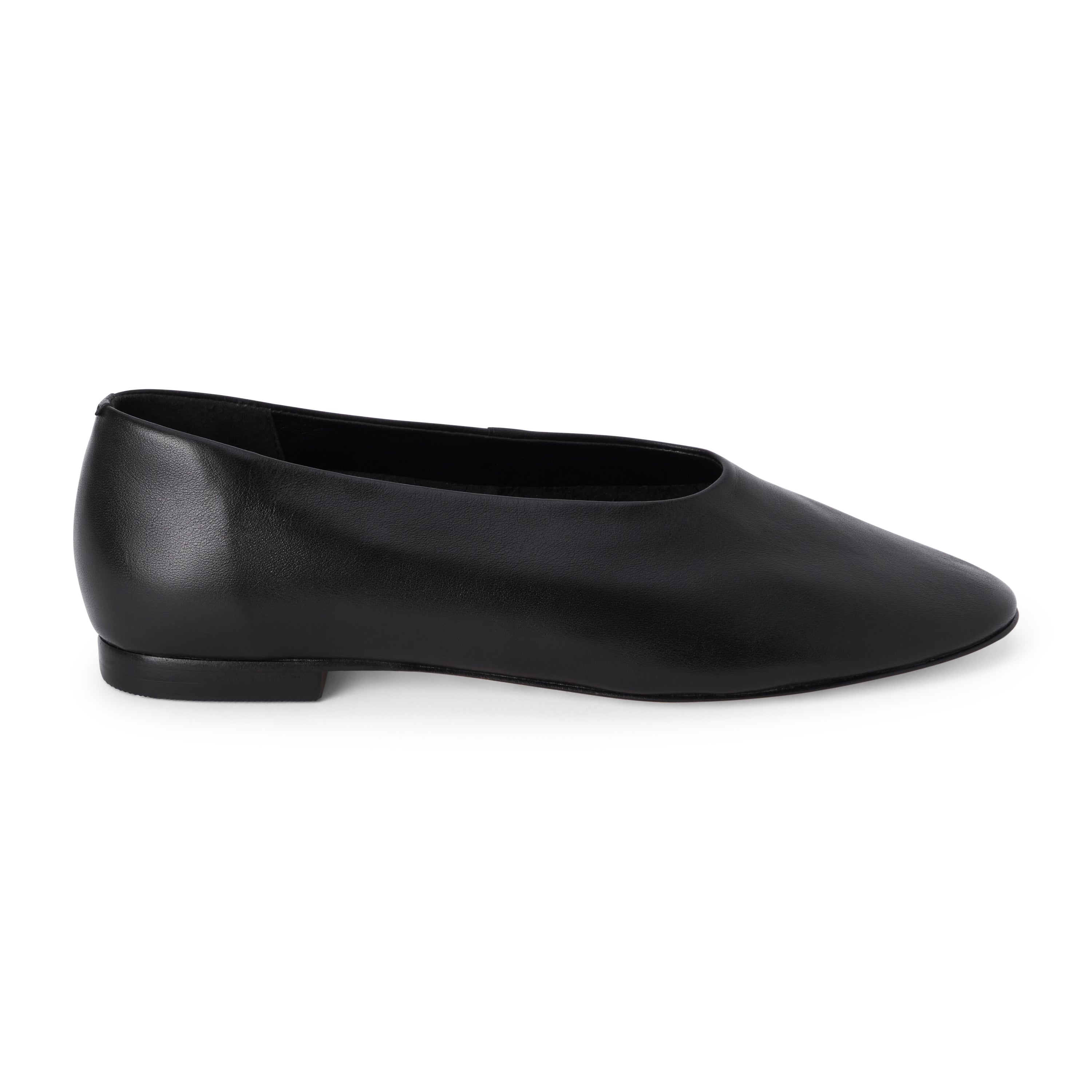 Black leather flat with a softly squared toe, high-cut vamp, smooth upper, and low black heel shown on a white background.