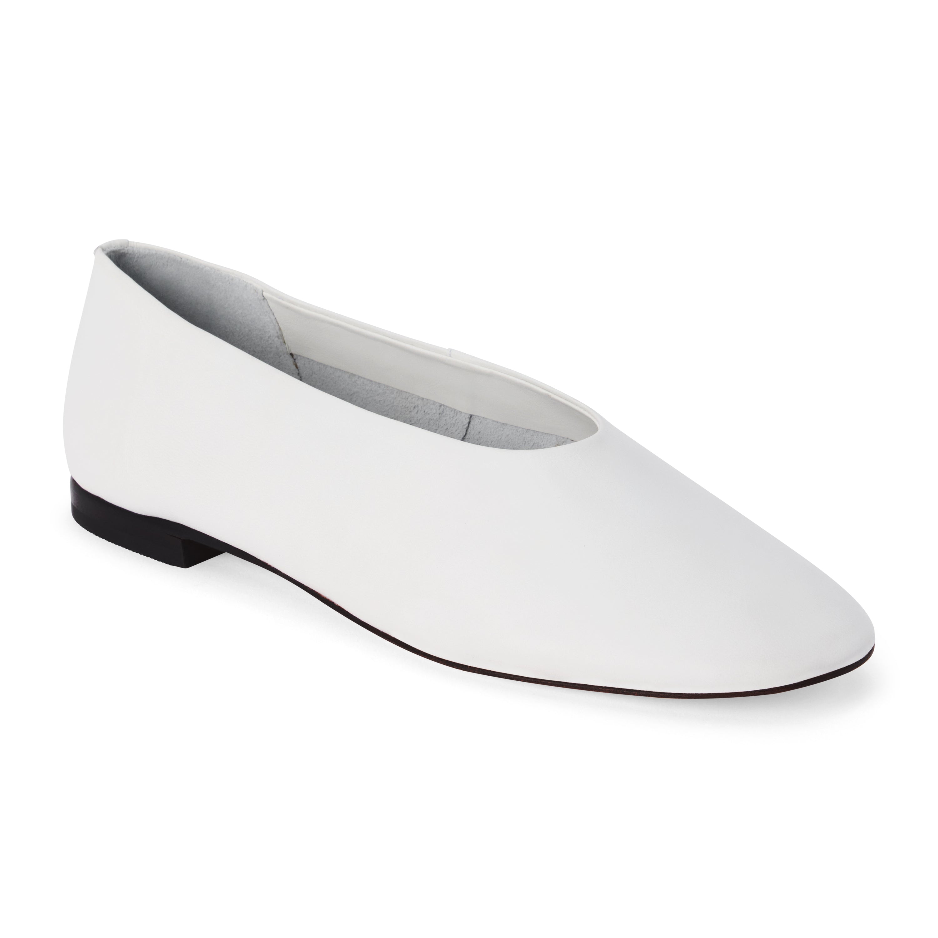 White leather flat with a softly squared toe, high-cut vamp, smooth upper, and low black heel shown on a white background.