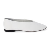 White leather flat with a softly squared toe, high-cut vamp, smooth upper, and low black heel shown on a white background.