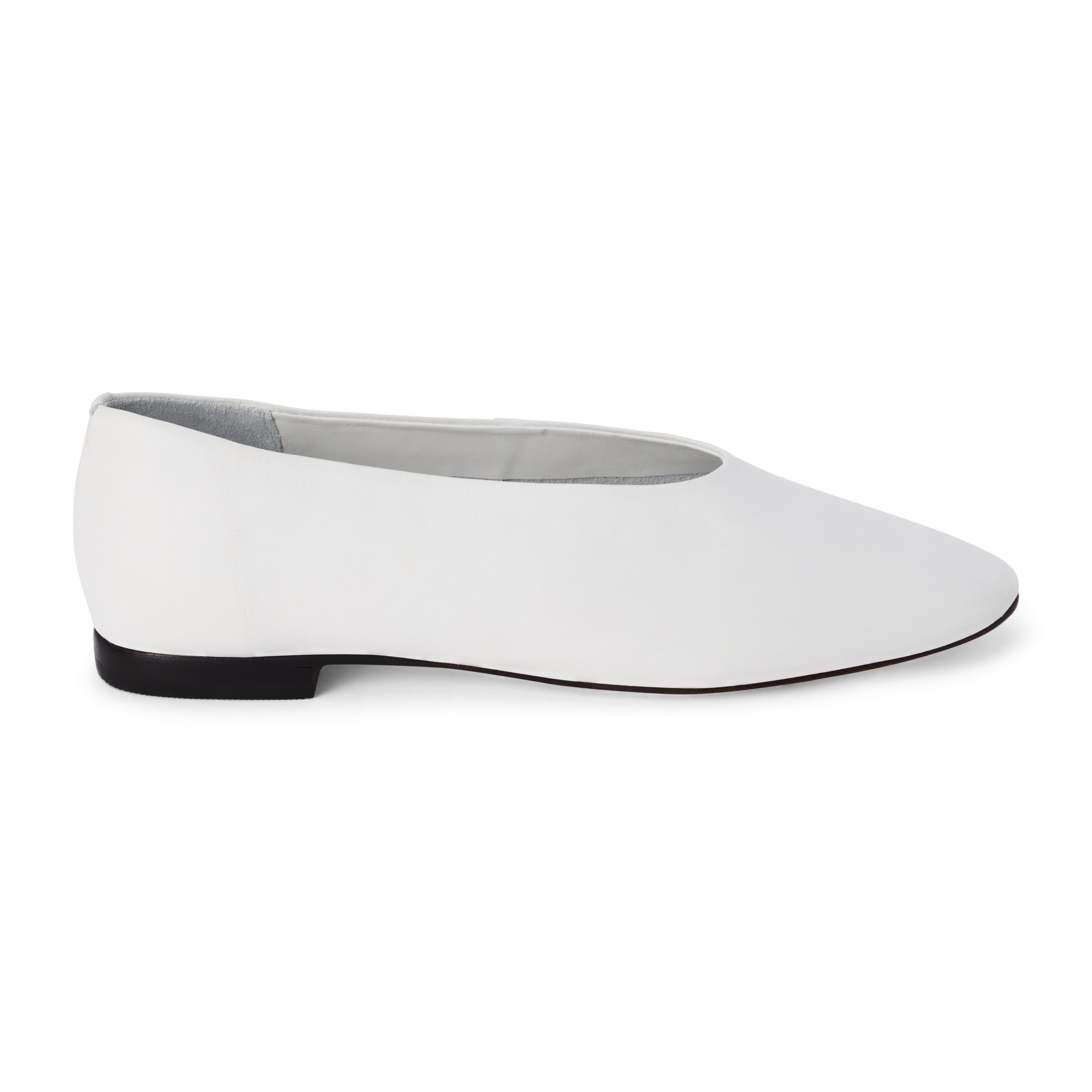 White leather flat with a softly squared toe, high-cut vamp, smooth upper, and low black heel shown on a white background.