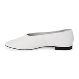 White leather flat with a softly squared toe, high-cut vamp, smooth upper, and low black heel shown on a white background.