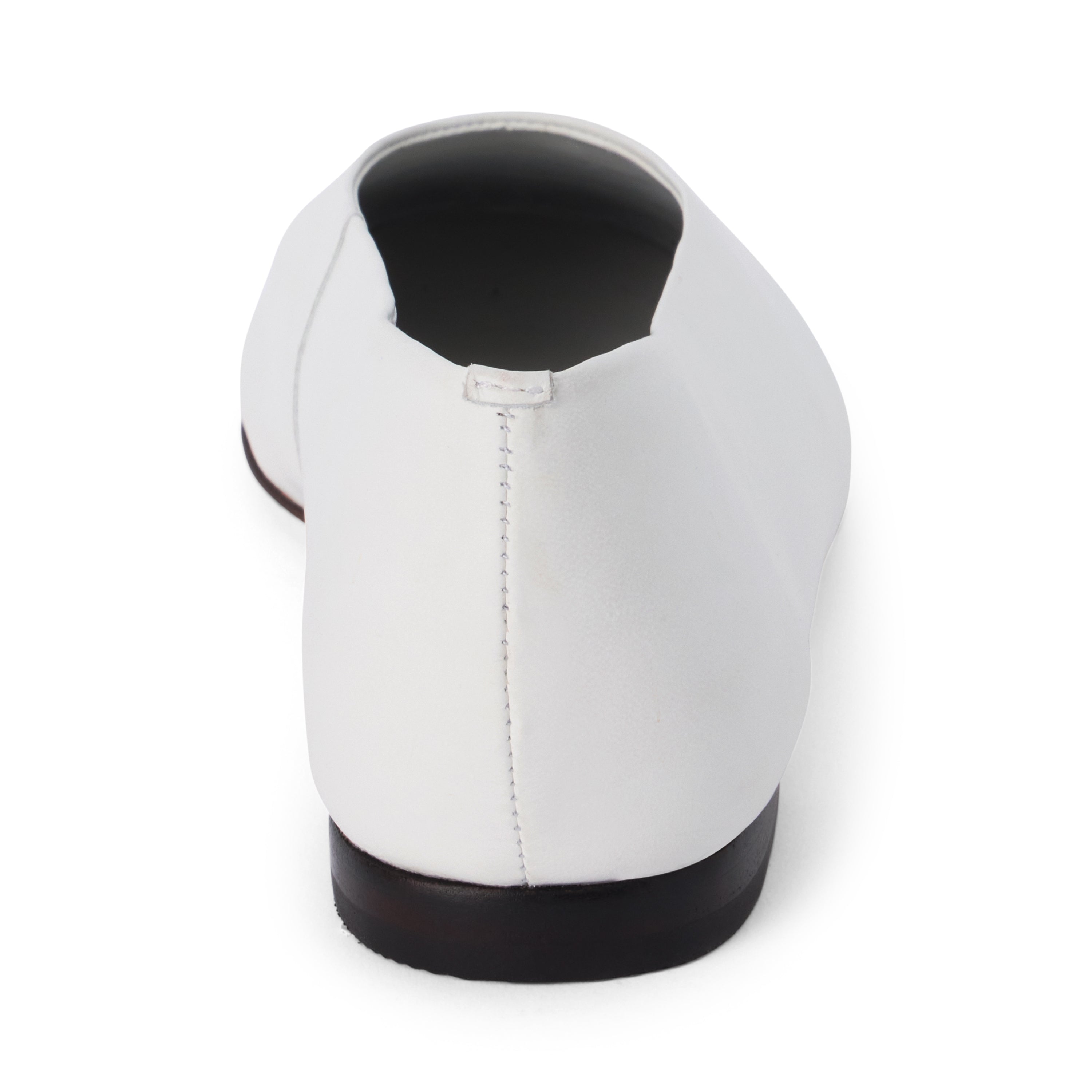 White leather flat with a softly squared toe, high-cut vamp, smooth upper, and low black heel shown on a white background.