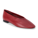 Red leather flat with a softly squared toe, high-cut vamp, smooth upper, and low dark heel shown on a white background.