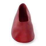 Red leather flat with a softly squared toe, high-cut vamp, smooth upper, and low dark heel shown on a white background.