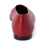 Red leather flat with a softly squared toe, high-cut vamp, smooth upper, and low dark heel shown on a white background.
