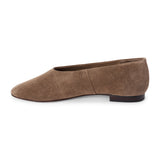 Brown suede flat with a softly squared toe, high-cut vamp, textured upper, and low dark heel shown on a white background.