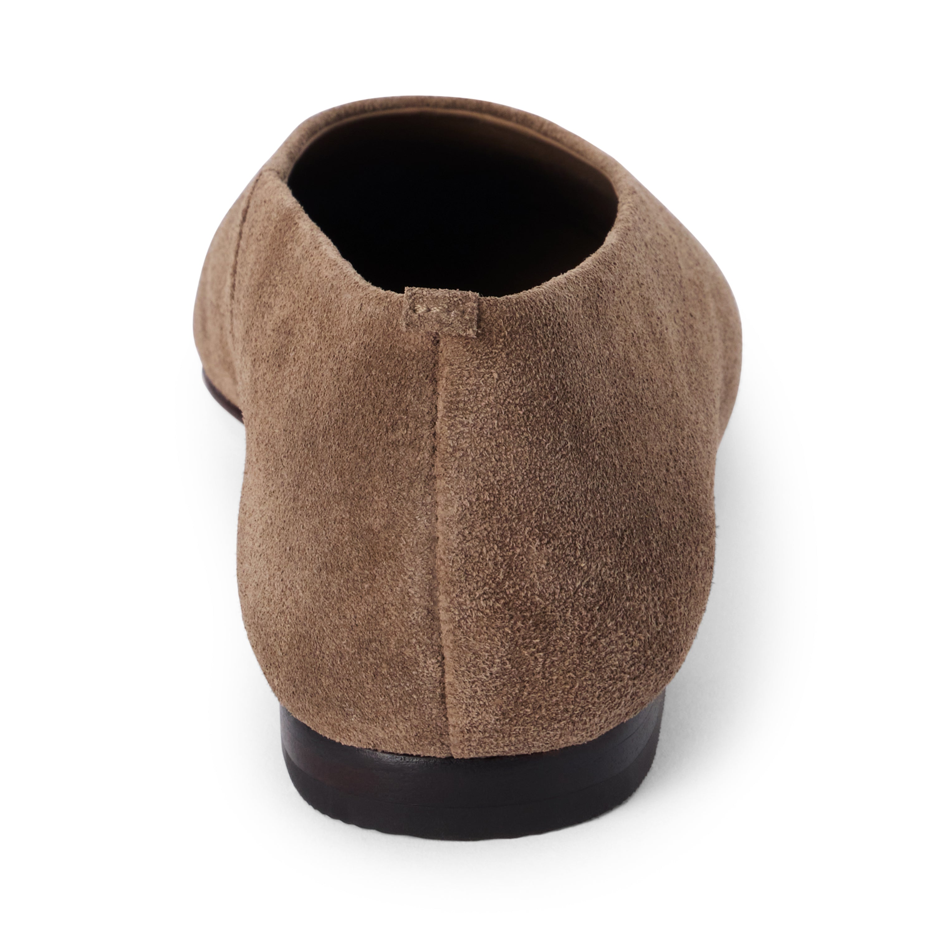 Brown suede flat with a softly squared toe, high-cut vamp, textured upper, and low dark heel shown on a white background.