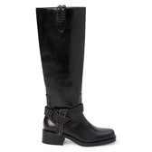 Black faux leather knee-high boot with a rounded toe, low block heel, and braided wraparound ankle detail shown on a white background.