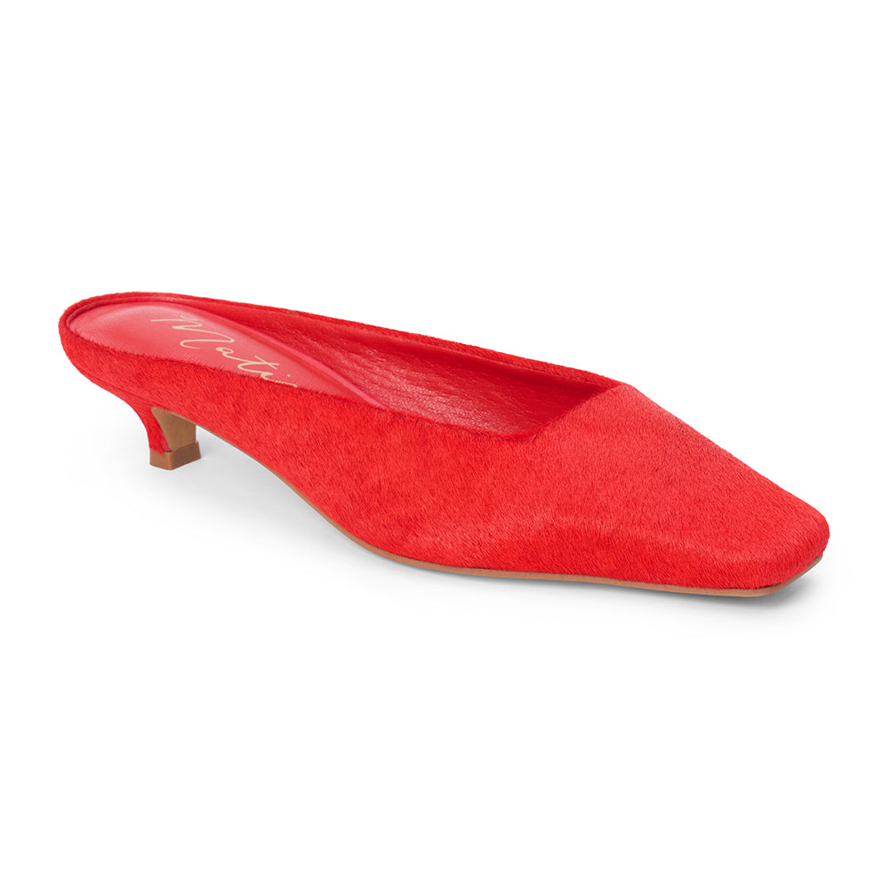 Red cow hair heeled mule with a pointed toe and low kitten heel shown on a white background.