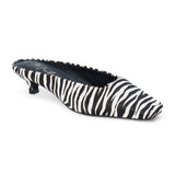 Ivory and black zebra-print cow hair heeled mule with a pointed toe and low kitten heel shown on a white background.