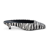 Ivory and black zebra-print cow hair heeled mule with a pointed toe and low kitten heel shown on a white background.