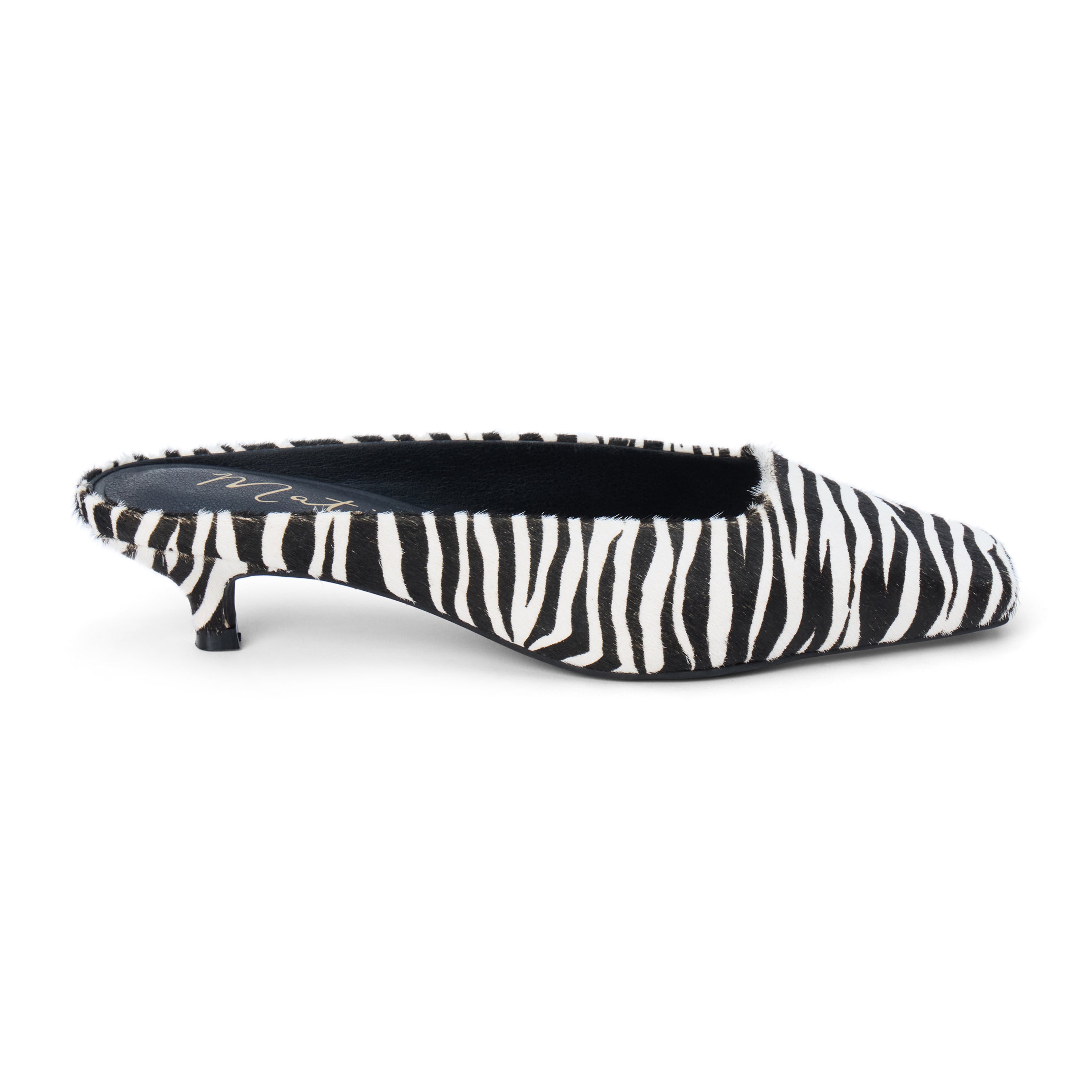 Ivory and black zebra-print cow hair heeled mule with a pointed toe and low kitten heel shown on a white background.