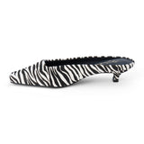 Ivory and black zebra-print cow hair heeled mule with a pointed toe and low kitten heel shown on a white background.