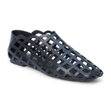 Black woven leather flat with a cage-style upper, almond toe, low profile sole, and closed heel, shown in side profile on a white background.