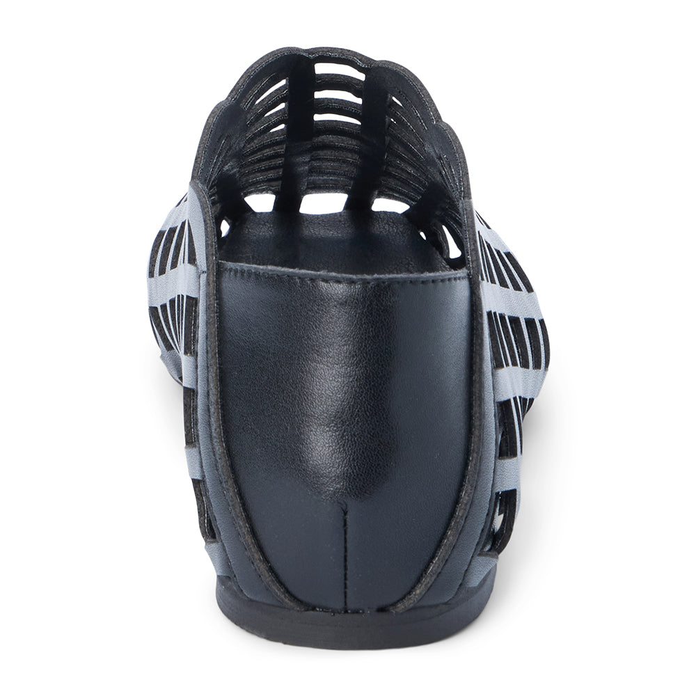Black woven leather flat with a cage-style upper, almond toe, low profile sole, and closed heel, shown in side profile on a white background.