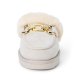 Vegan grey faux suede mule with plush faux-fur trim, gold-tone hardware, a moc toe, and platform sole shown on a white background.